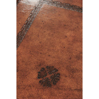 Close-up of intricate pattern on leather serving tray.
