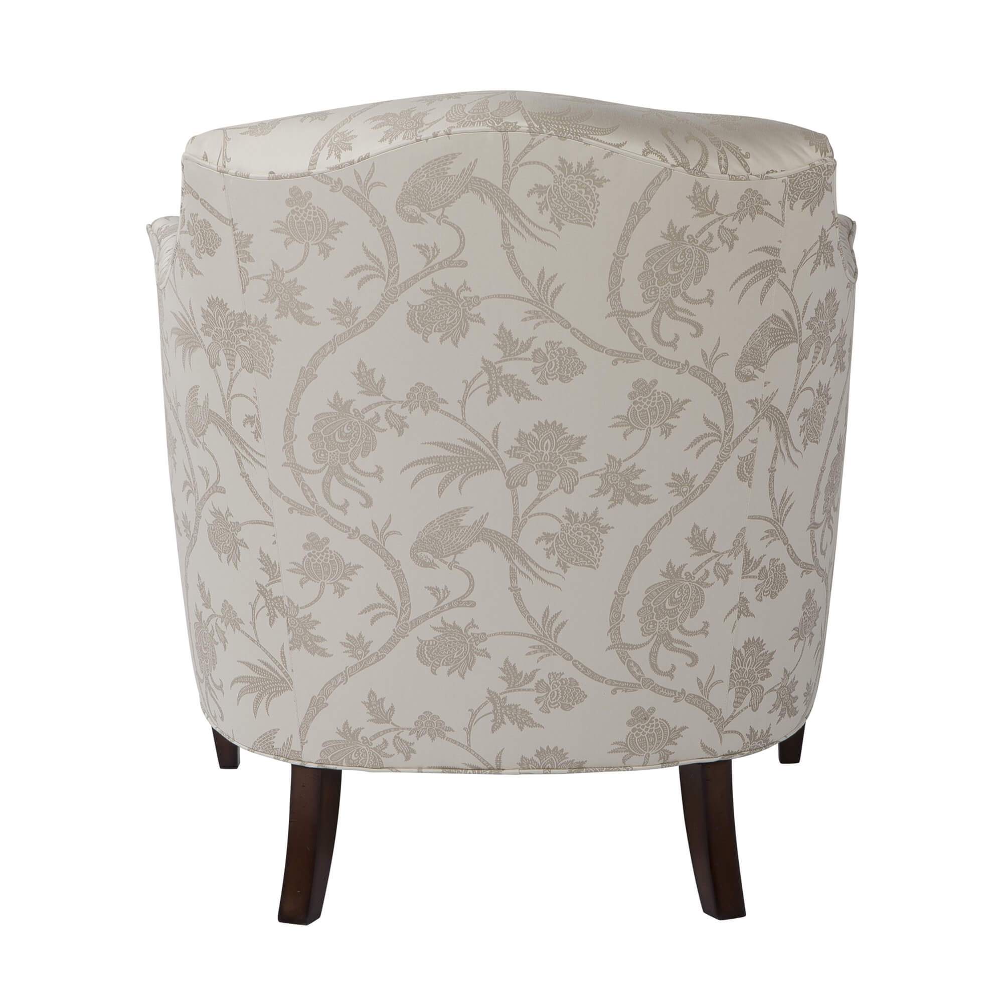 Floral patterned armchair, back view, wooden legs.