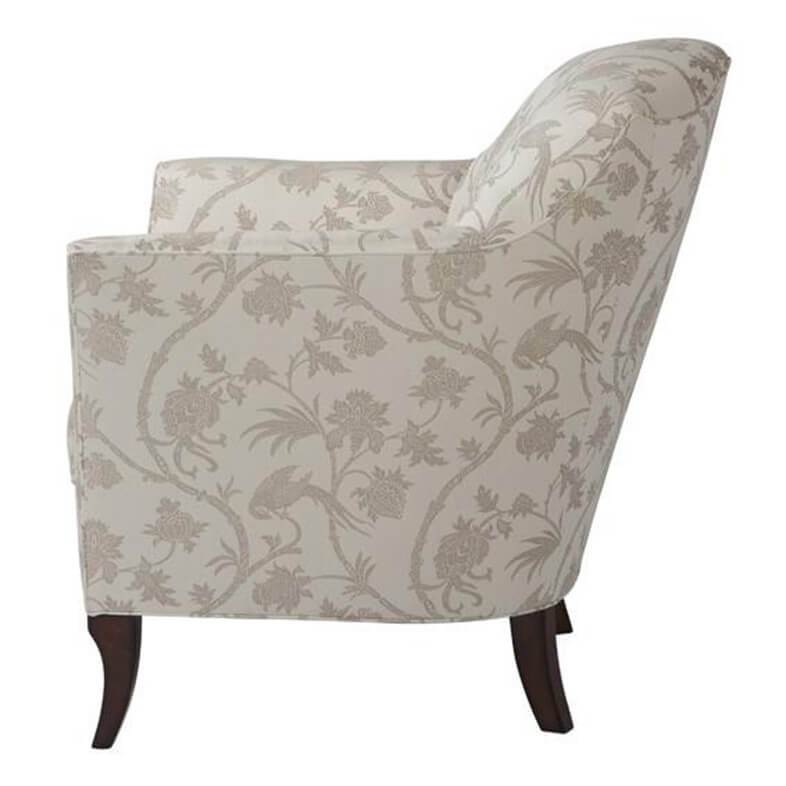 Floral patterned armchair, side view, wooden legs.