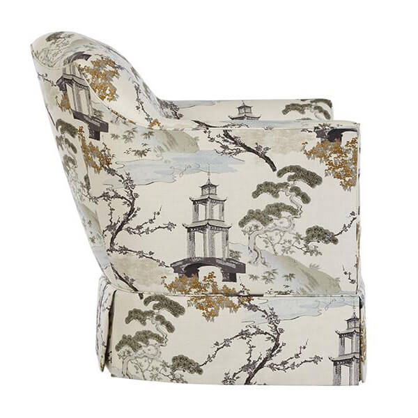Beige armchair with nature print, side view.