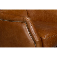 Close-up of arm detail on brown leather chair