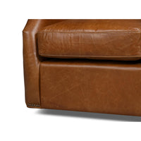 Base and cushion detail on brown leather chair
