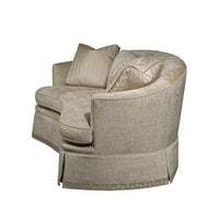 Side view of curved back sofa with pillows.