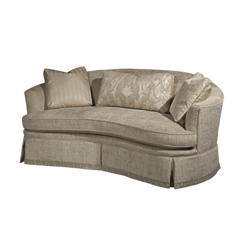 Curved back sofa with cushions, angled view.