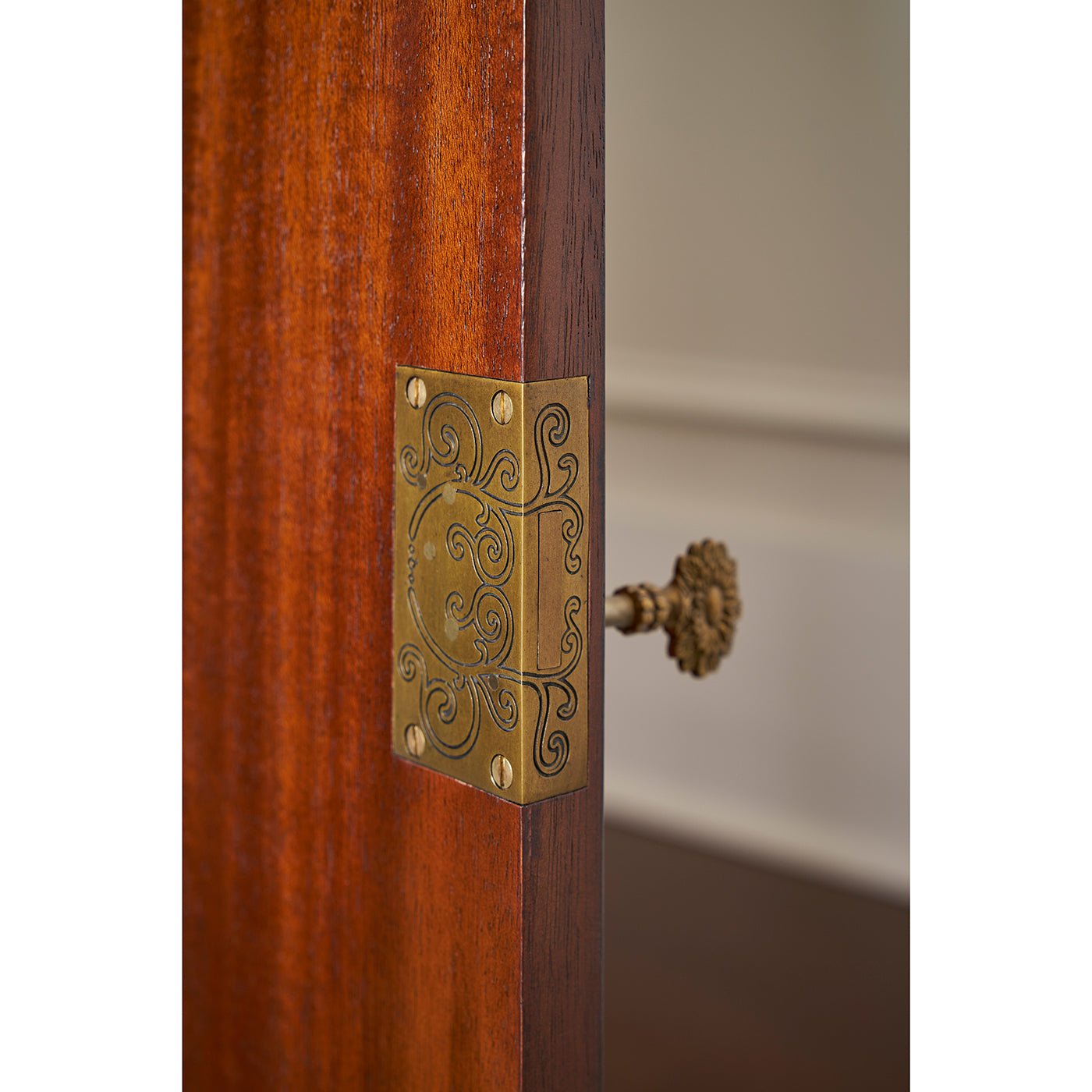 Close-up of sideboard hinge and ornate design.
