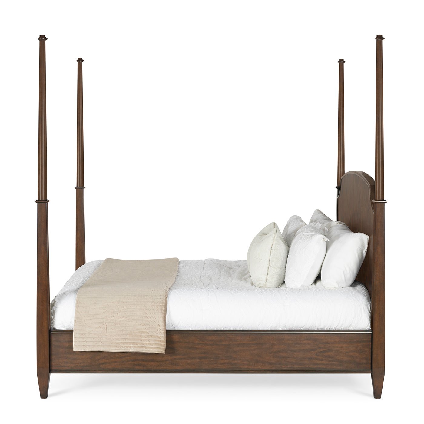 Side view of traditional king poster bed, with bedding.