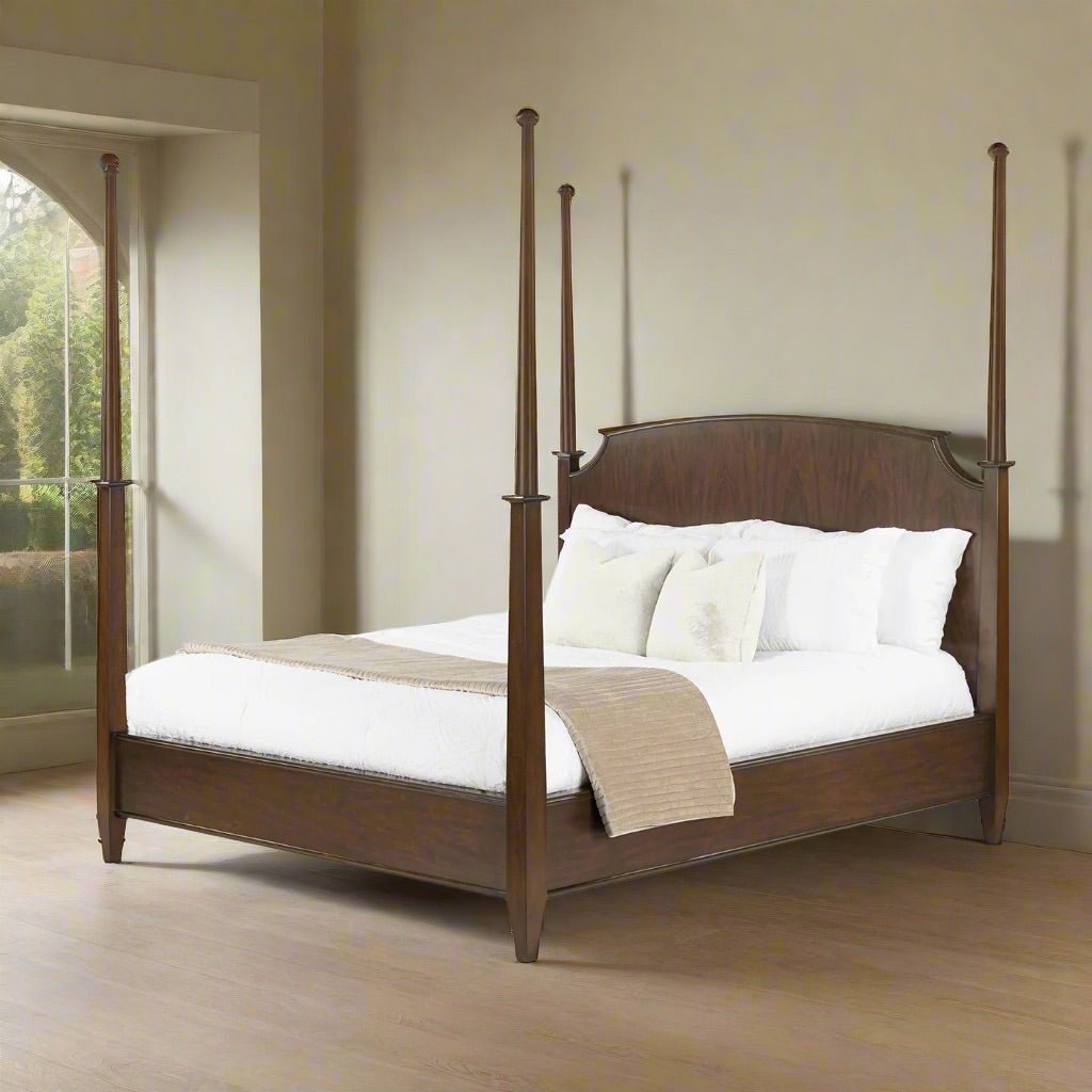 Traditional king poster bed in room setting, side view.