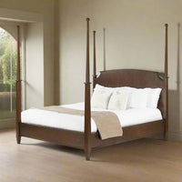 Traditional king poster bed in room setting, side view.