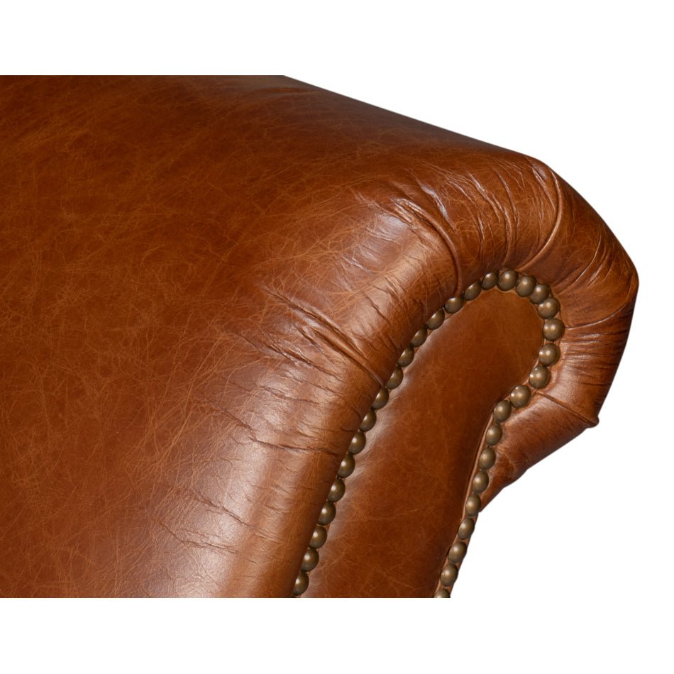 Rolled backrest close-up with nailhead trim.