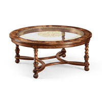 Round coffee table with glass inset, angled view.