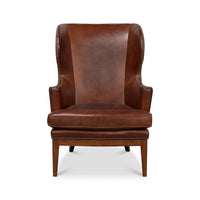 Brown leather wing chair front view.