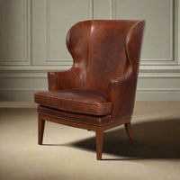 Brown leather wing chair in room setting.