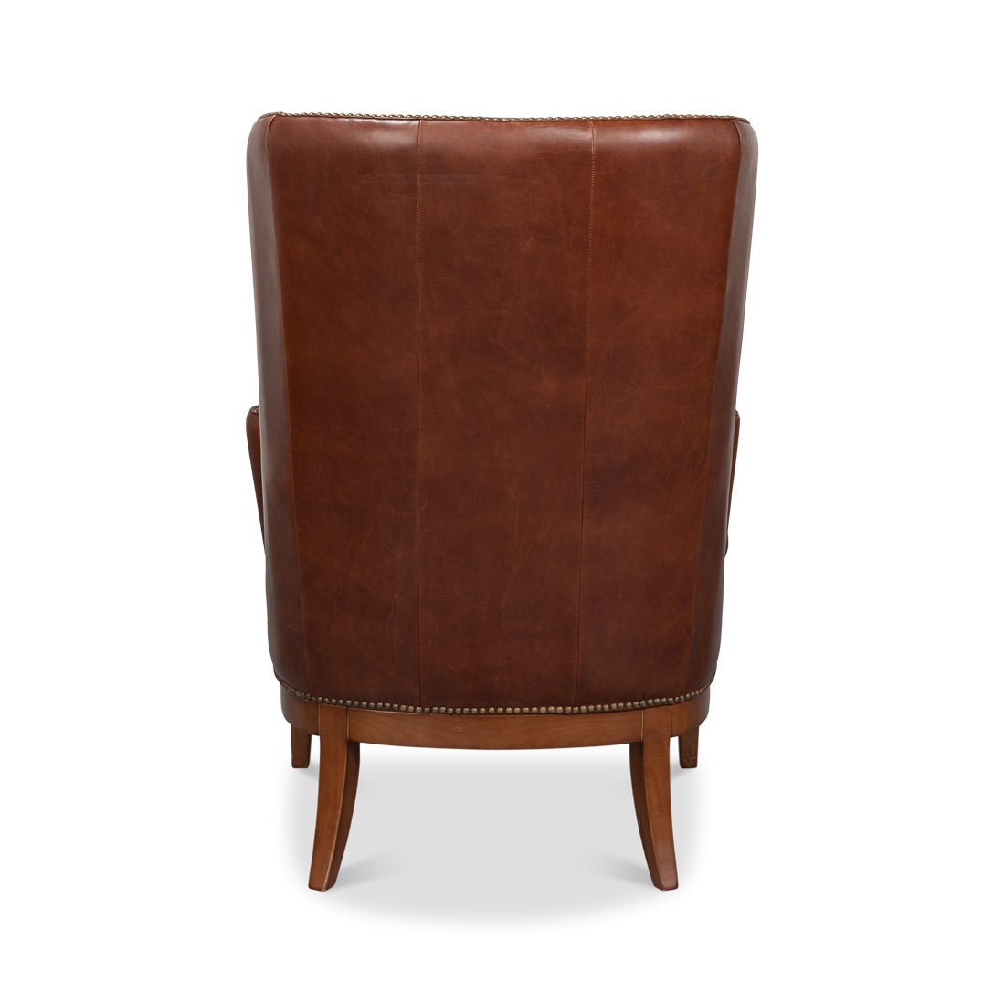 Brown leather wing chair back view.