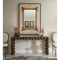Mirror above wooden table, elegant room decor.