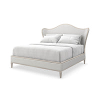 Silver upholstered king bed, angled view, transitional style.