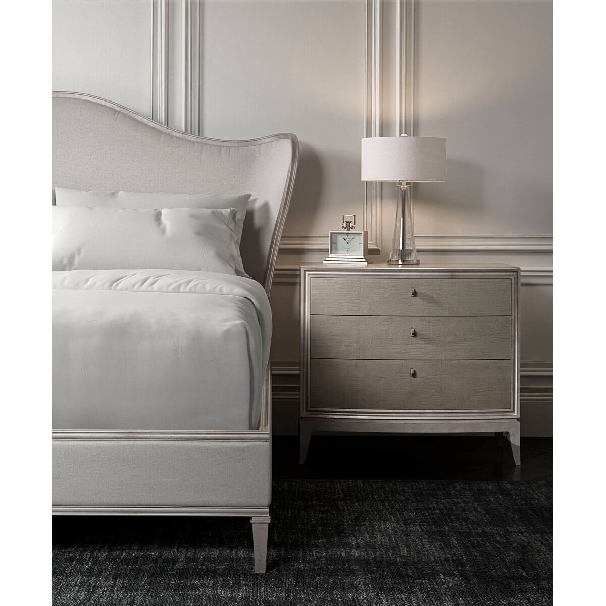 Close-up of silver bed and nightstand in bedroom.