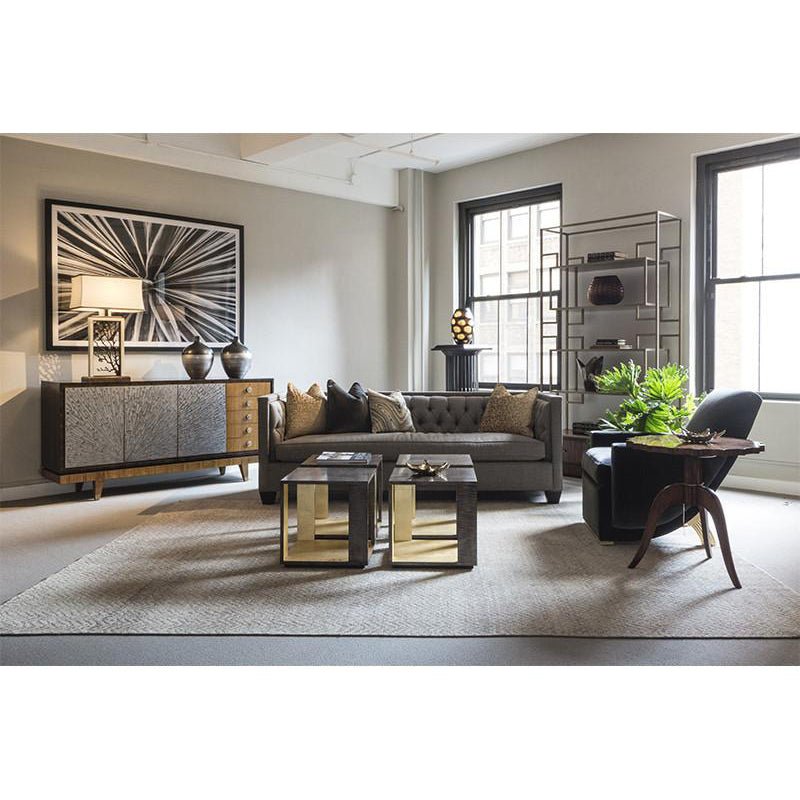 Living room with beige tufted sofa in stylish decor.