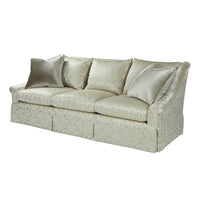 Angled view of transitional upholstered sofa with pillows.