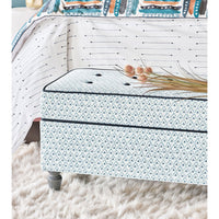 Trellis print ottoman styled in bedroom setting.
