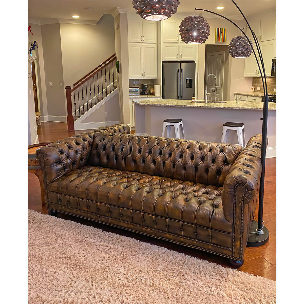 Chesterfield sofa in living room setting, cozy and stylish.