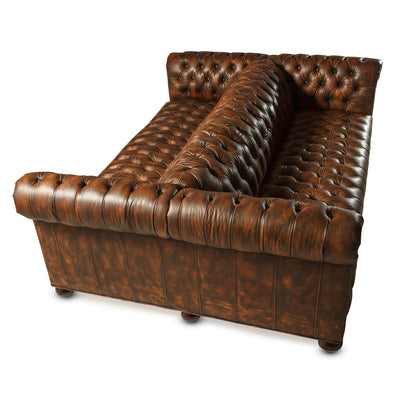 Double-sided tufted Chesterfield sofa, overhead view, rich leather.