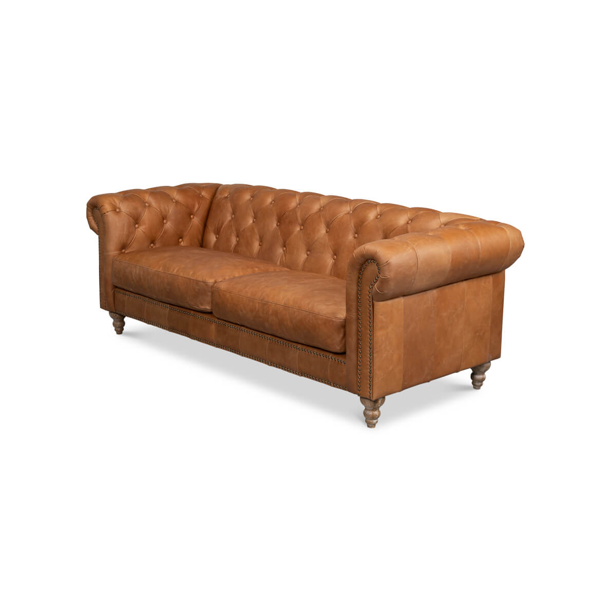 Tufted leather chesterfield sofa angled side view.