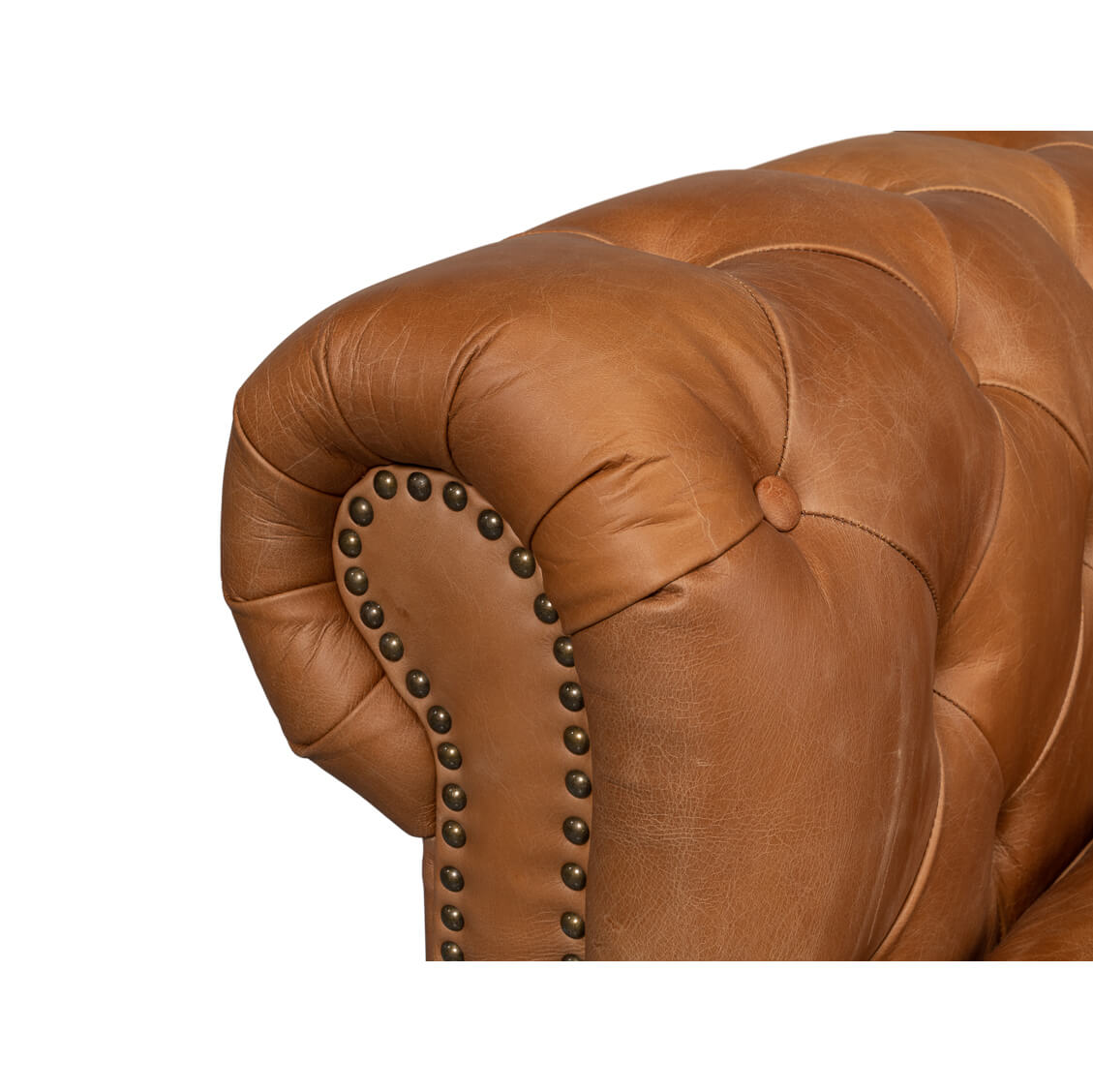 Close-up arm details tufted chesterfield sofa.