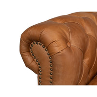 Close-up arm details tufted chesterfield sofa.