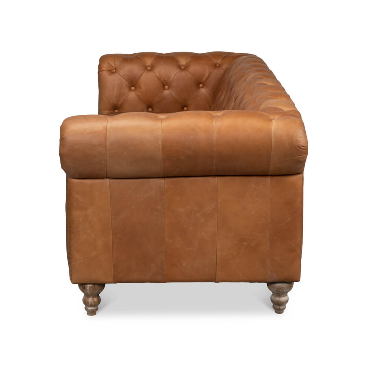 Side view of tufted leather chesterfield sofa.