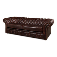 Angled view tufted leather Chesterfield sofa, brown upholstery.