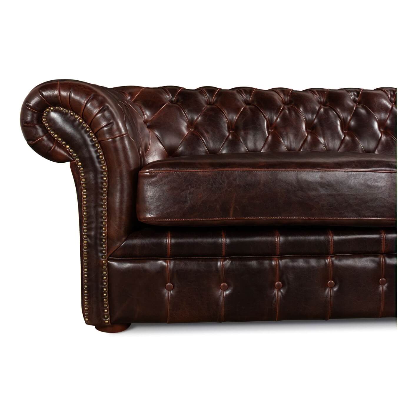 Close-up tufted leather Chesterfield sofa arm, nailhead trim.