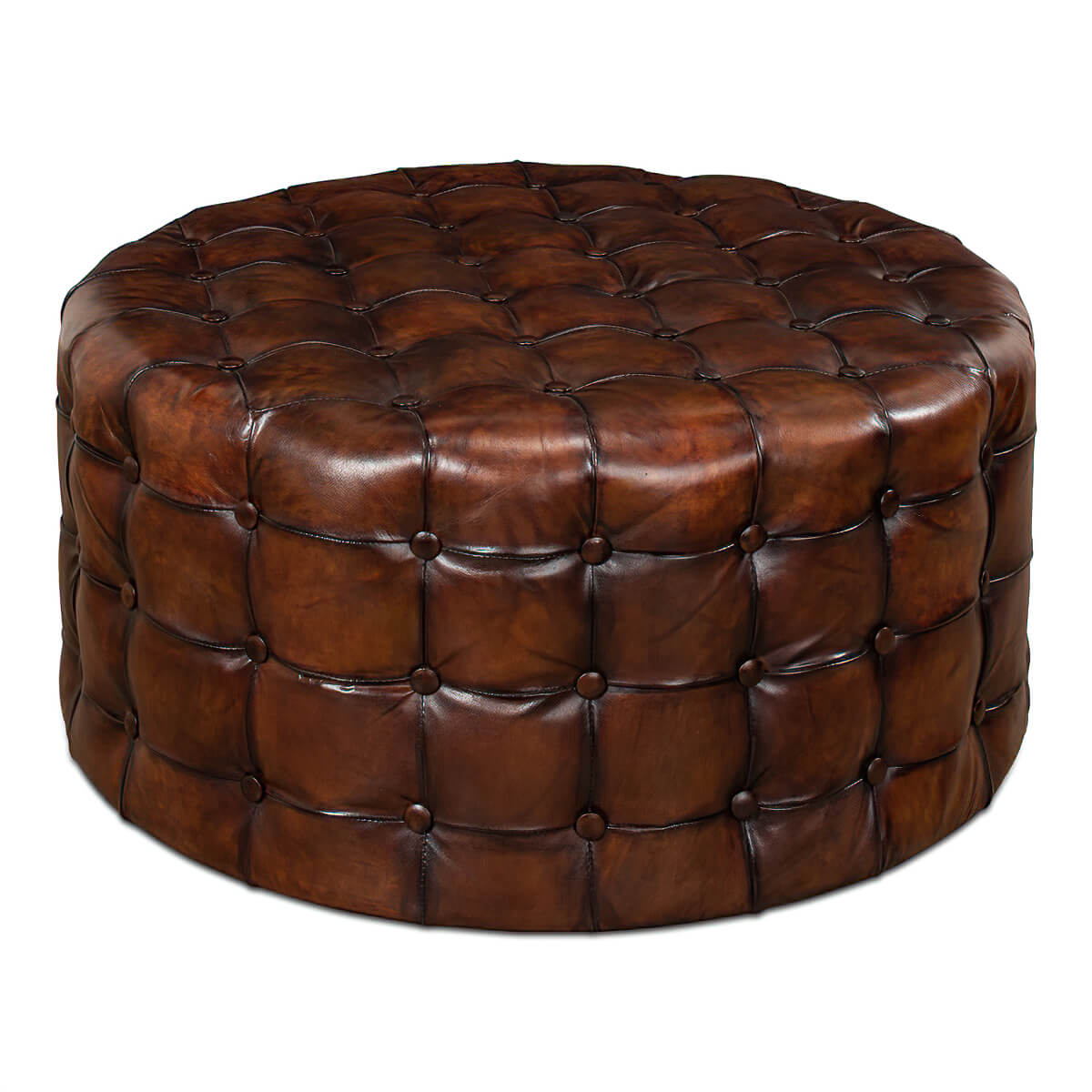 Round leather ottoman, tufted finish, front view.