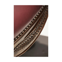 Ornate wood carving detail on chair's edge.