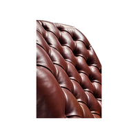 Close-up tufted red leather texture on chair.
