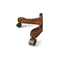 Wood caster base detail on office chair.