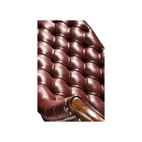 Close-up tufted backrest detail red leather chair.