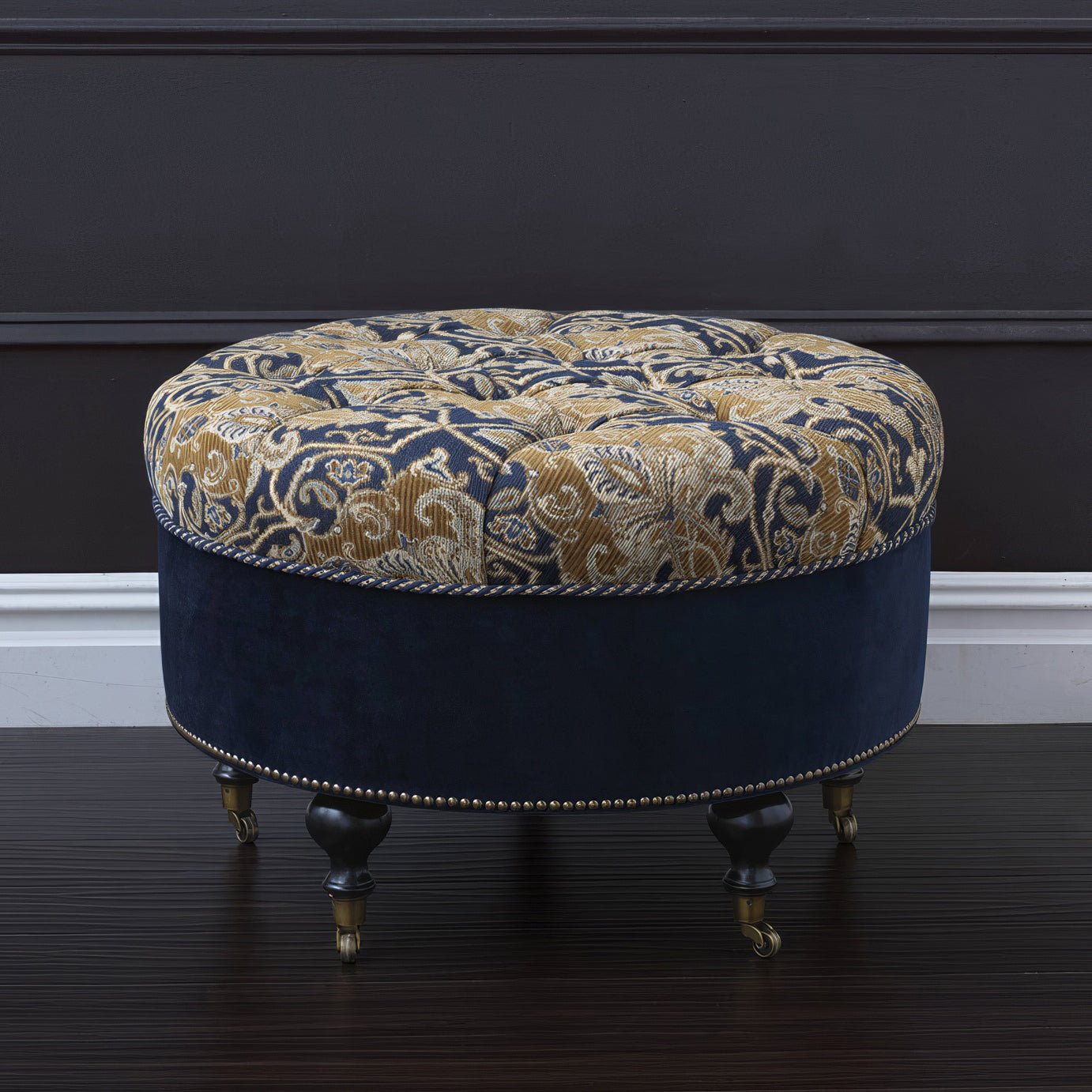 Elegant tufted ottoman with intricate pattern on dark surface.
