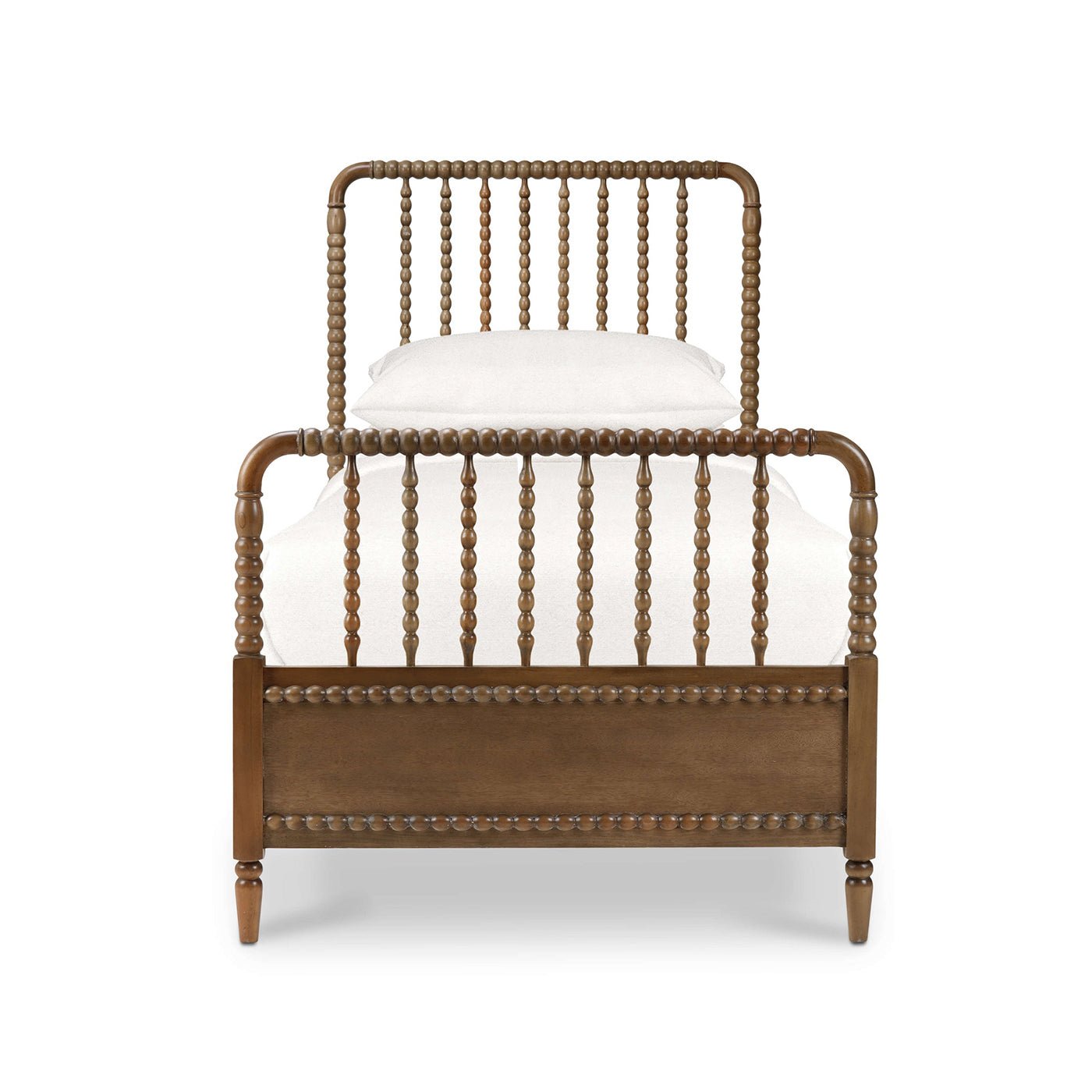 Wooden twin spindle bed, head-on view with pillows.