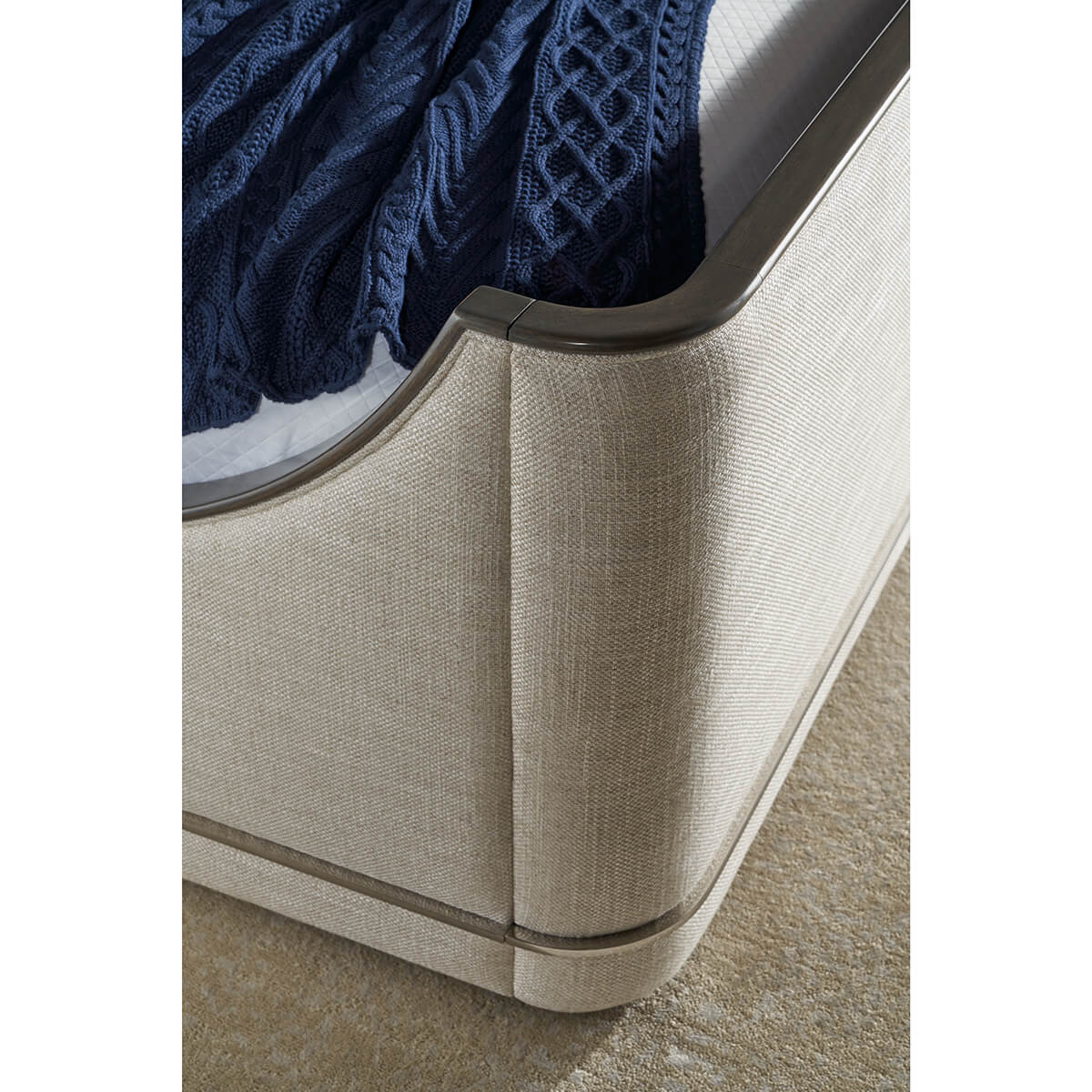 Close-up corner detail of upholstered Art Deco bed.