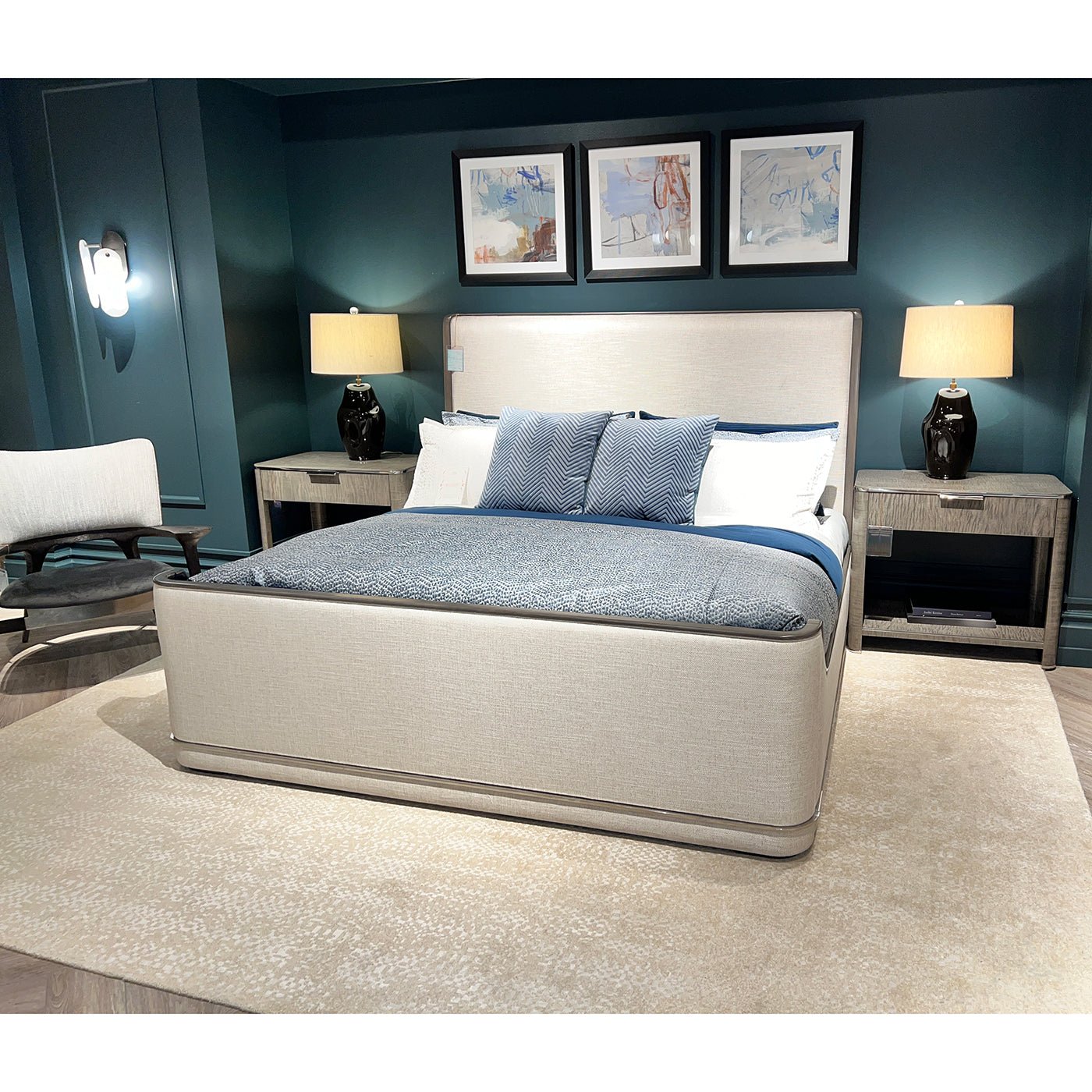 Upholstered Art Deco bed in decorated room with blue accents.