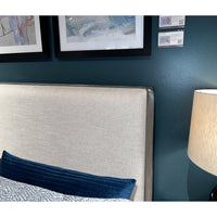 Headboard detail of upholstered Art Deco bed with decor.