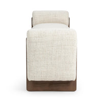 End view of the Sand upholstered bench showing its rounded padded arm and ash base