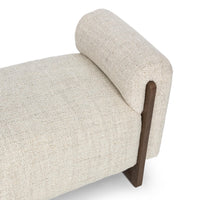 Close-up of the Sand bench’s pale woven seat, rounded arm and exposed ash support
