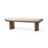 Upholstered bench at an angle, with a pale cushion, upturned wood frame ends and two broad rounded supports