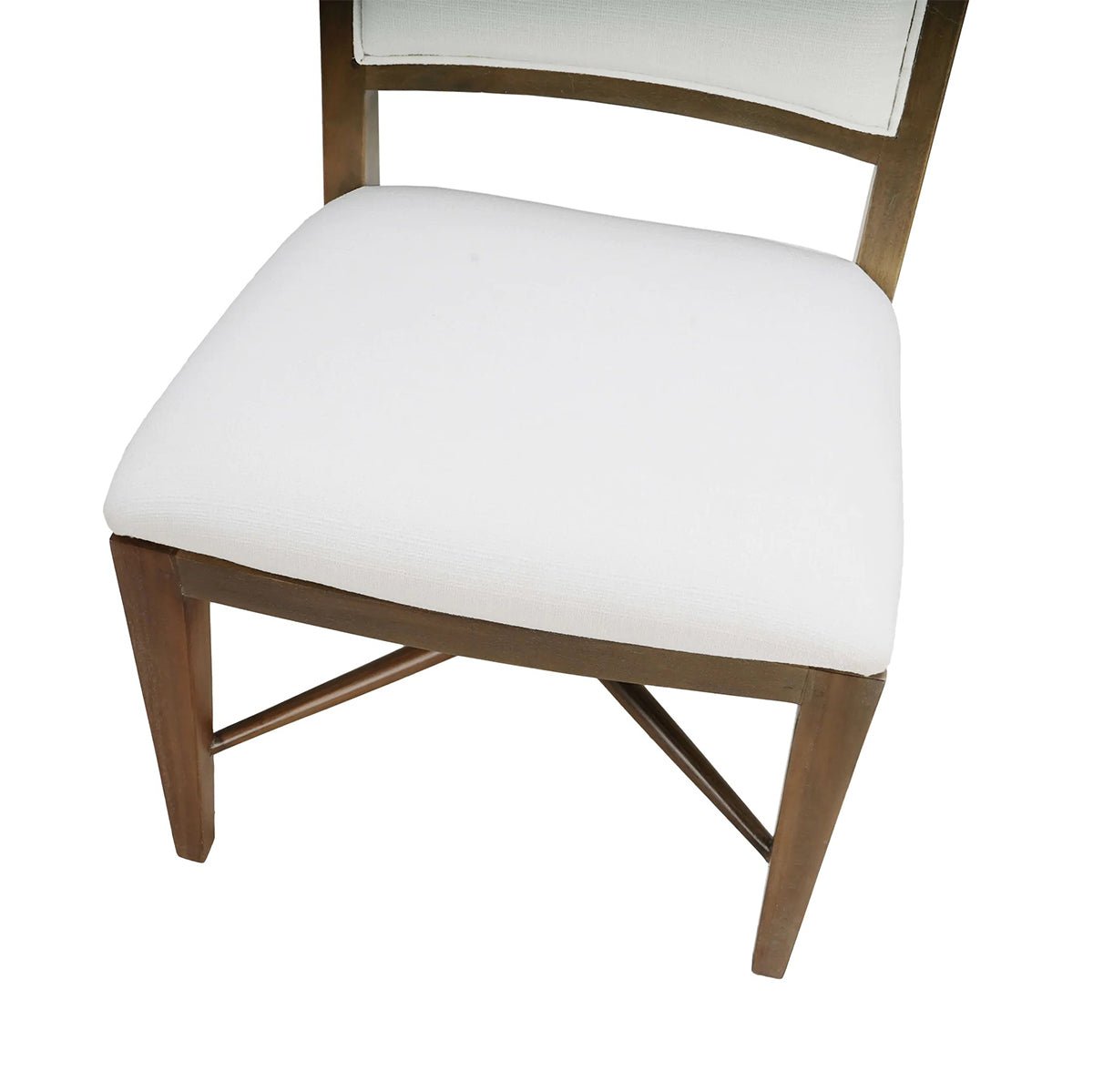 Dining chair seat detail, white upholstery and wooden legs.
