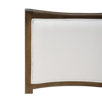 Close-up of dining chair backrest, white fabric and wood.