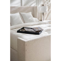 Close-up, bed with book tray and bedding.