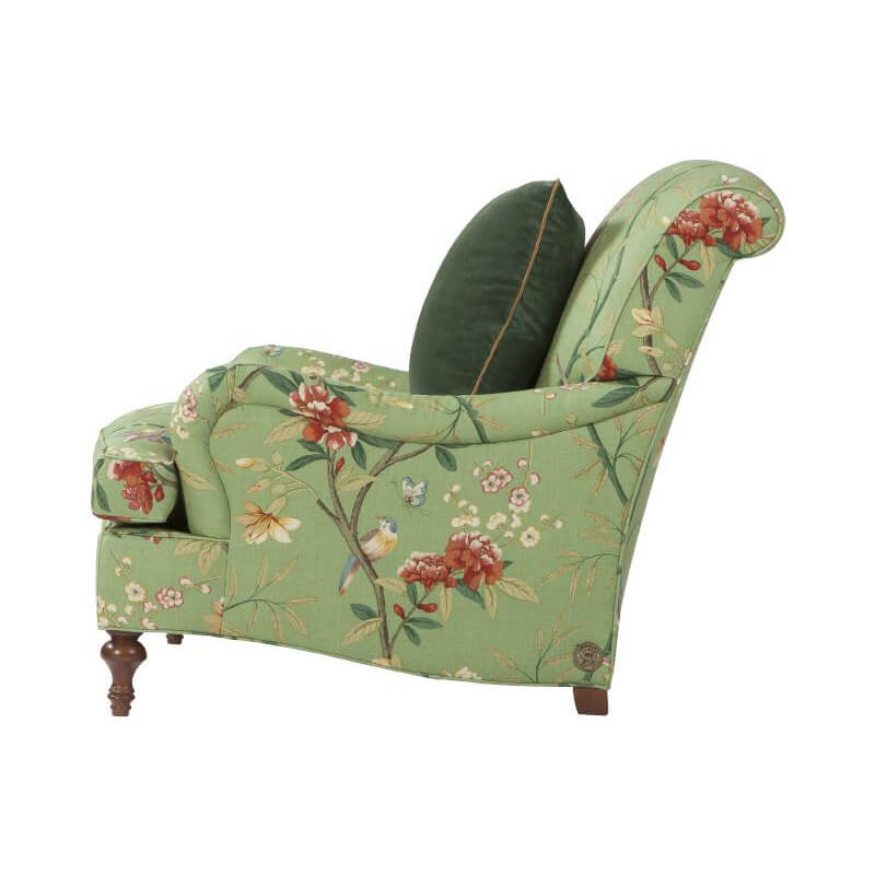 Side view of green floral Victorian easy chair design.