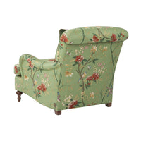 Green floral Victorian-style armchair, back decorative pattern.