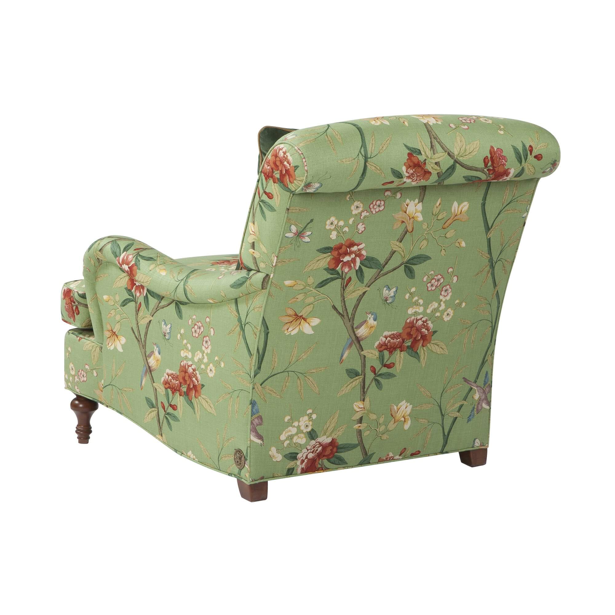 Green floral Victorian-style armchair, back decorative pattern.